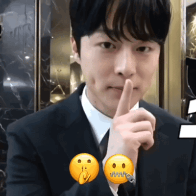 Man in Suit Making Shhh Gesture