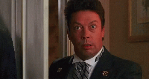 Man in Suit Making Surprised Face in Doorway