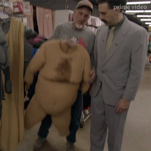 Man in Suit Next to Big Belly Suit