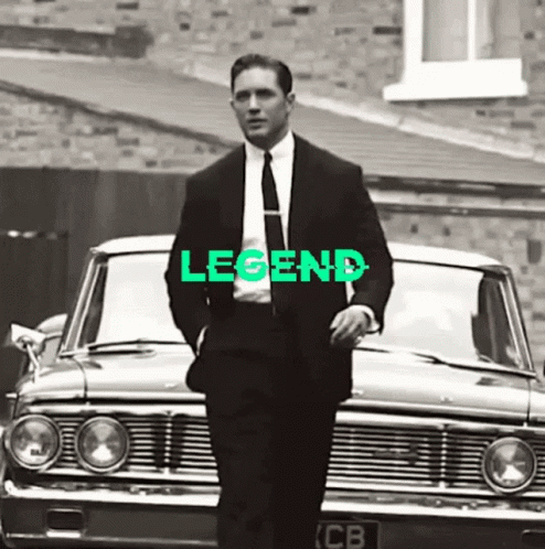 Man In Suit Next To Car With Legend GIF