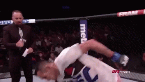 Man In Suit Next To Fighter In Cage GIF
