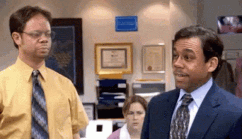Man in Suit Next to Man in Yellow Shirt