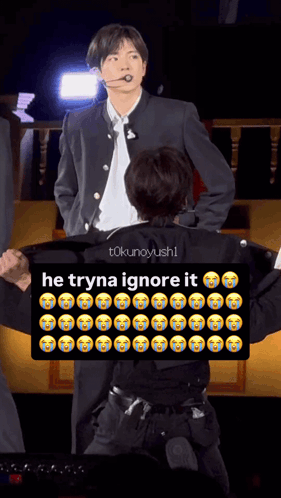 Man in Suit Next to Man With Sign Saying He Tryna Ignore It