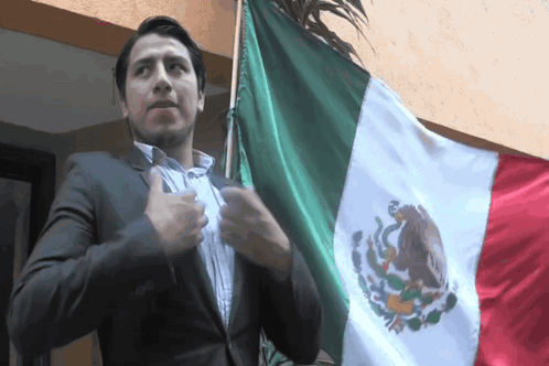 Man in Suit Next to Mexican Flag