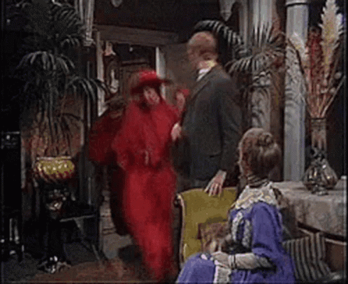 Man In Suit Next To Woman In Red Dress GIF