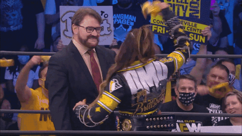 Man In Suit Next To Woman In Wrestling Ring Monroeville Convention GIF