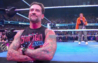 Man in Suit Next to Wrestler