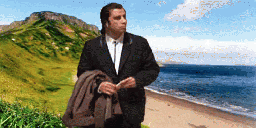 Man in Suit on Beach with Mountain