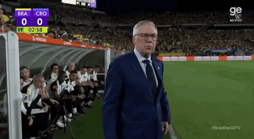 Man In Suit On Soccer Field Scoreboard Bra 0 Cro 0 GIF