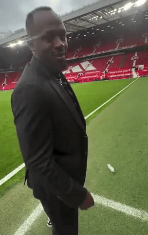 Man in Suit on Soccer Field