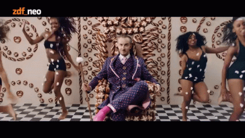 Man In Suit On Throne Surrounded By Dancing Women ZDF Neo GIF