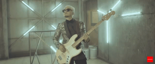 Man in Suit Playing Bass Guitar