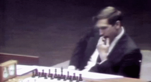 Man in Suit Playing Chess