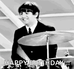 Man In Suit Playing Drum Set Smiling GIF