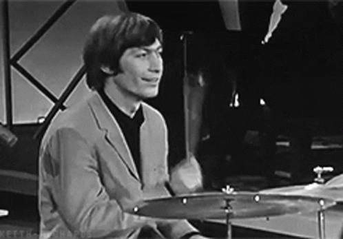 Man in Suit Playing Drums Black and White