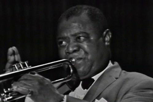 Man in Suit Playing Trumpet