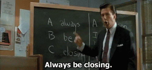 Man in Suit Pointing at Blackboard Saying Always Be Closing