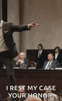 Man in Suit Pointing at Jury in Courtroom