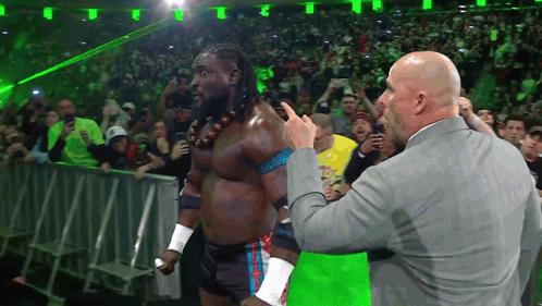 Man in Suit Pointing at Wrestler in Ring
