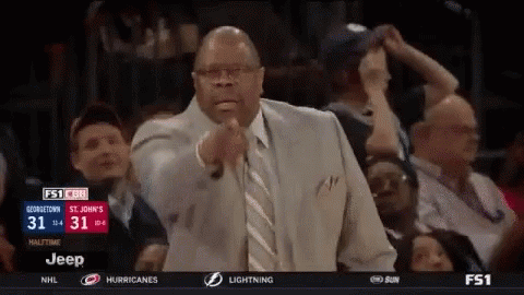 Man in Suit Pointing During Basketball