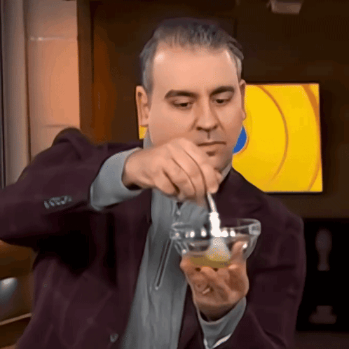 Man in Suit Pouring Into Small Bowl