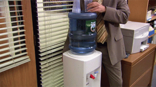 Man in Suit Pouring Water Bottle Ups