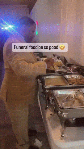 Man In Suit Preparing Food For Funeral GIF