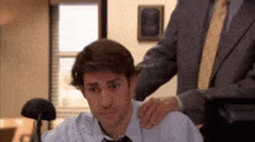 Man in Suit Puts Hand on Colleague's Shoulder