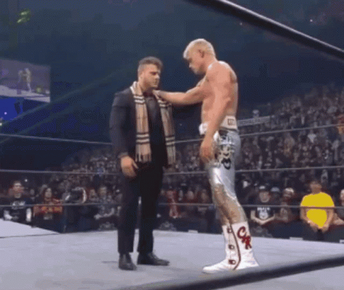 Man in Suit Putting Scarf on Wrestler