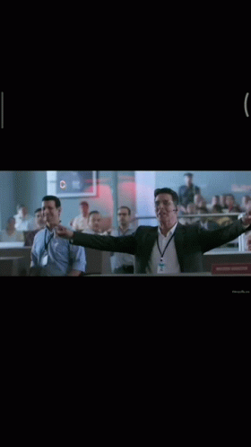 Man in Suit Raising Arms Saying Copy That