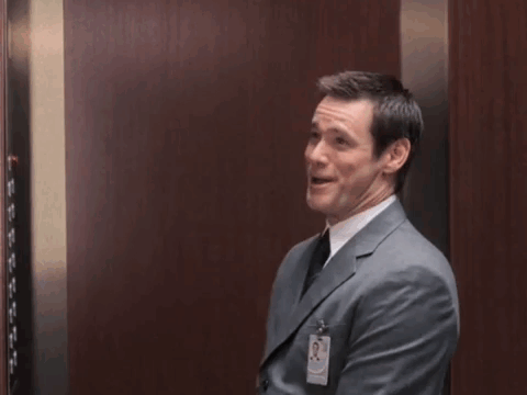 Man in Suit Raising Fists in Elevator