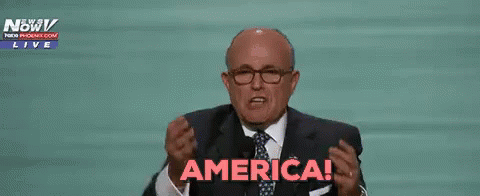 Man in Suit Raising Hands Saying America