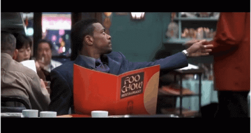 Man in Suit Reading Menu