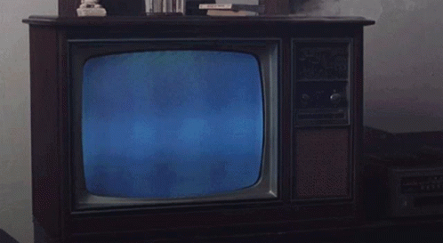 Man in Suit Reading Newspaper on Television