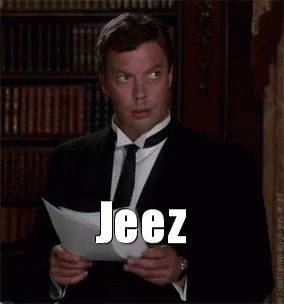 Man in Suit Reading Paper Saying Jeez