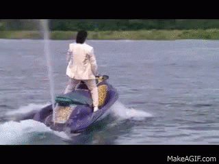 Man in Suit Riding Jet Ski in Lake
