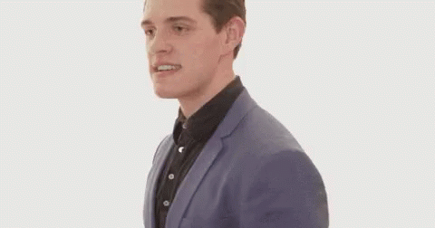 Man in Suit Running and Making Face