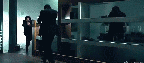 Man in Suit Running in Dark Room