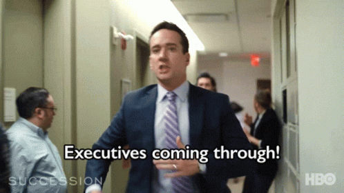 Man In Suit Running Says Executives Coming Through GIF