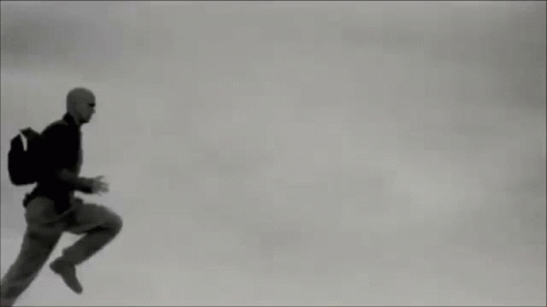 Man in Suit Running Through Air