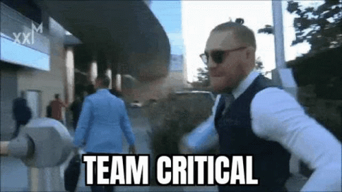 Man in Suit Running with Team Critical