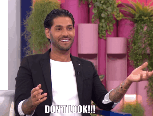 Man In Suit Saying Don't Look Arms Outstretched GIF