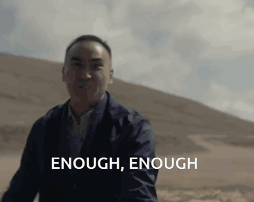 Man in Suit Saying Enough Enough in Front of Hill