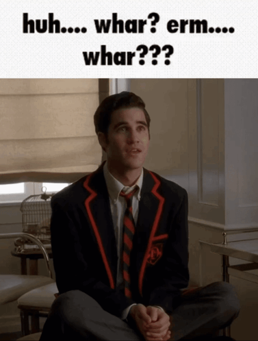 Man In Suit Saying Huh Whar Erm GIF