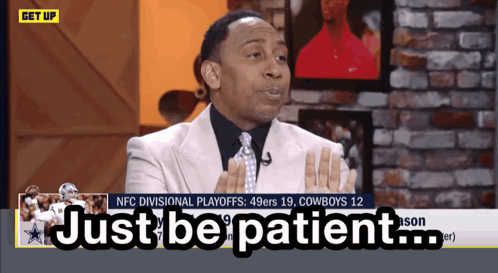 Man in Suit Saying Just Be Patient on TV Screen