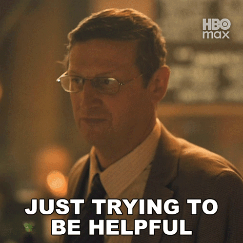 Man in Suit Saying Just Trying to Be Helpful
