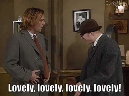 Man In Suit Saying Lovely To Man In Hat GIF