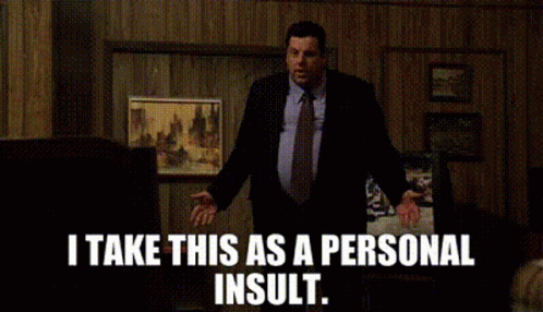 Man in Suit Saying Personal Insult