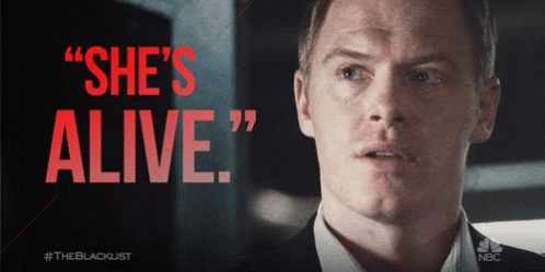 Man in Suit Saying She's Alive in Red