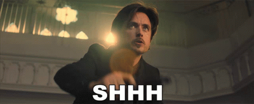 Man in Suit Saying Shhh